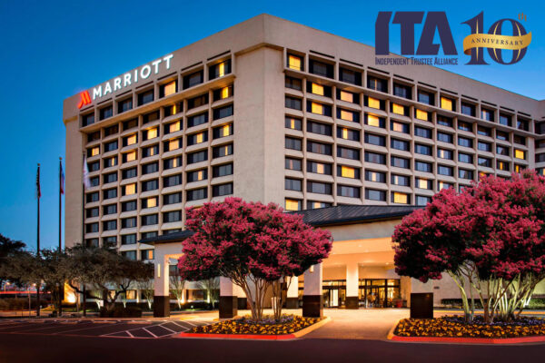 Exterior of the Galleria Marriott Hotel at dusk, where the Annual Conference is held each year, along with the ITA 10th Anniversary logo in blue and gold.